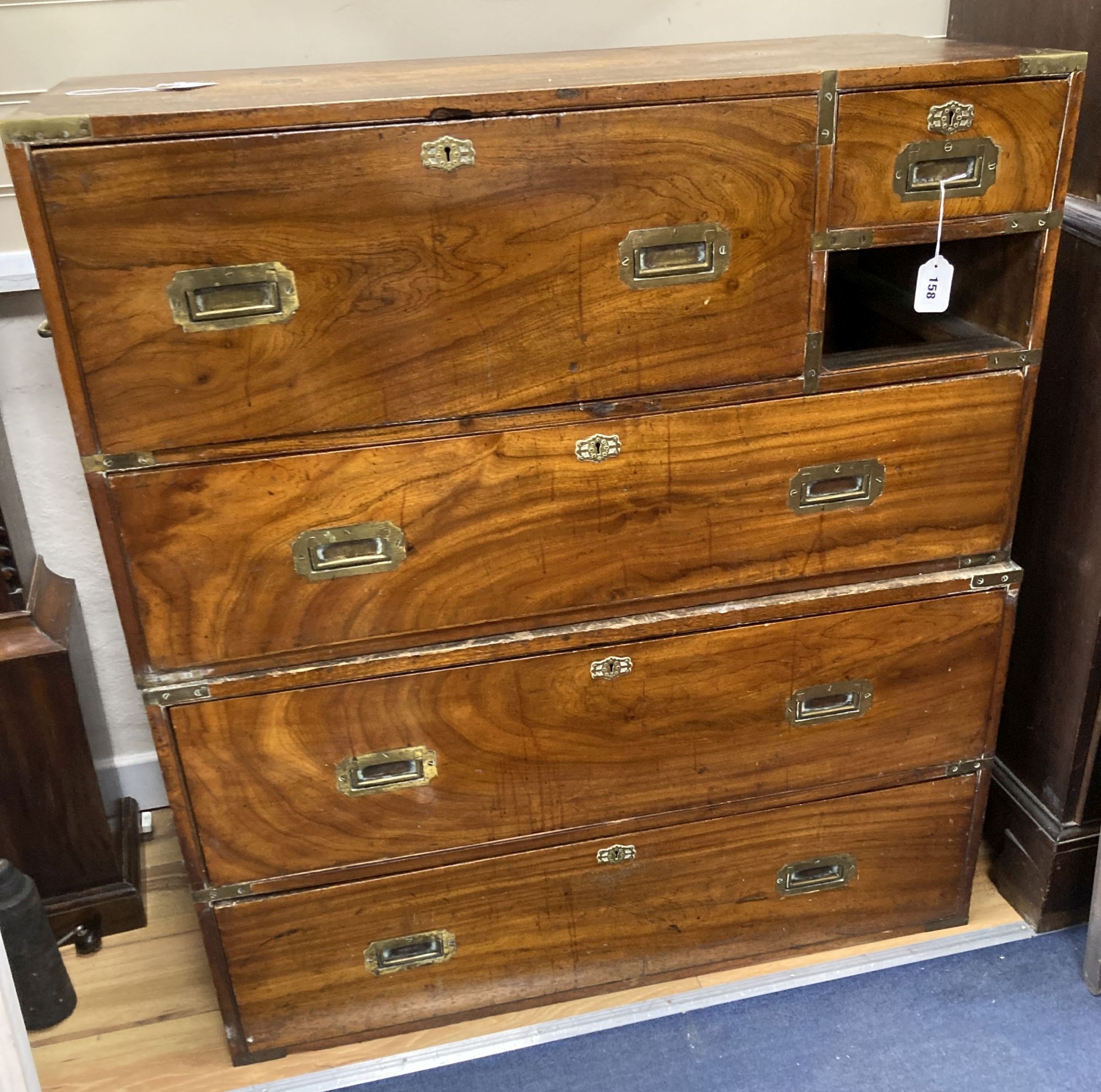 A 19th century brass mounted teak two part military chest (lacking one drawer) width 97cm, depth 46cm, height 107cm